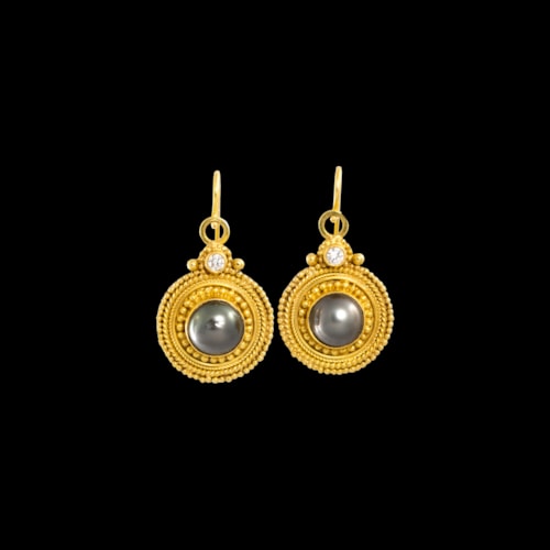 A pair of Etruscomania gold earrings.